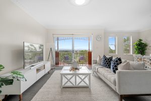 Bright living room with balcony access and leafy outlook at 17/67 Woniora Rd, HURSTVILLE NSW 2220
