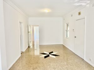 Spacious living area with terrazzo flooring and decorative inlay at 35 Churchill Crescent, Concord NSW 2137