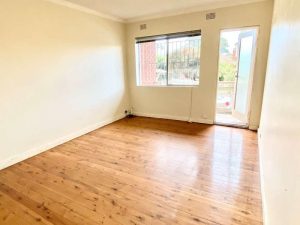 Living room with timber floors and balcony access at 5/147 The Boulevarde, Punchbowl NSW 2196