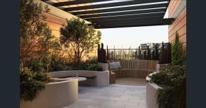 Landscaped rooftop terrace with built-in seating, pergola, and city outlook at a1208/499 Botany Road, Zetland NSW