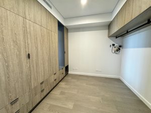 Unfurnished bedroom with full-height built-in wardrobes and timber flooring at a1208/499 Botany Road, Zetland NSW