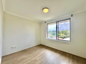 Bedroom with timber flooring and window outlook at 9/48 Station Street, Mortdale NSW 2223