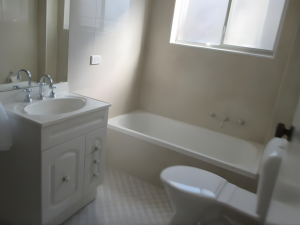 Light-filled bathroom with white vanity, bathtub, toilet, and frosted window at 14/12–16 Jersey Avenue, Mortdale NSW