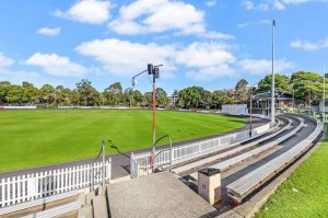 Local sports oval with grandstand seating, running track, and surrounding greenery near 4/81–83 Dora Street, Hurstville NSW 2220