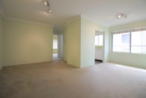 Open-plan living and dining area with soft carpet and natural light in Penshurst apartment