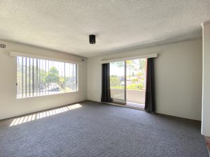 Living room with large window and balcony access at 4/25 Romilly Street, RIVERWOOD NSW 2210
