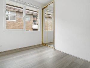Bedroom with mirrored built-in wardrobe and timber flooring at 12/67 Warialda Street, Kogarah NSW 2217