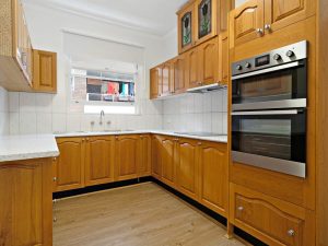 Timber kitchen with electric oven, ample cabinetry and window at 12/67 Warialda Street, Kogarah NSW 2217