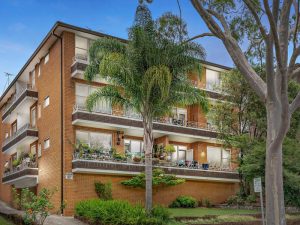 Exterior of a brick apartment building with balconies and landscaped gardens at 12/67 Warialda Street, Kogarah NSW 2217