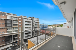 Balcony with glass balustrade and elevated urban outlook at 712/12 Bonar Street, Arncliffe NSW 2205