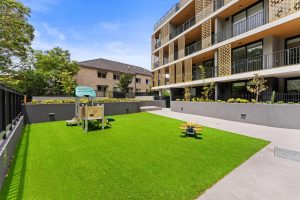 Communal landscaped courtyard with children’s playground at b604/1 Ashton Street, Rockdale NSW 2216