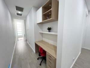 Hallway study nook with built-in desk and shelving at 31A Lawrence St, Peakhurst NSW 2210