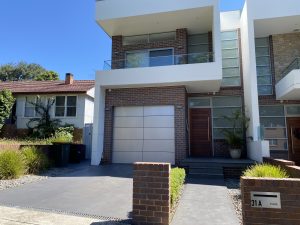 Modern townhouse façade with garage and balcony at 31A Lawrence St, Peakhurst NSW 2210