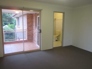 Bedroom at 10/50 Melvin Street, Beverly Hills NSW 2209 with carpeted flooring, sliding glass