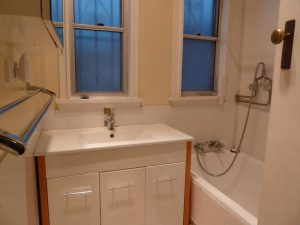 Bathroom at 37 Martin Street, Roselands NSW 2196 with vanity basin, bathtub with shower fittings, wall-mounted tapware, and frosted windows